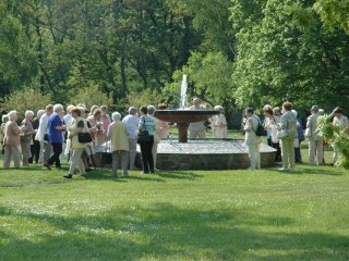 A group of pensioners standing at the father-fountain