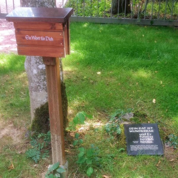 Plaque and box with bookmarks at a cemetary